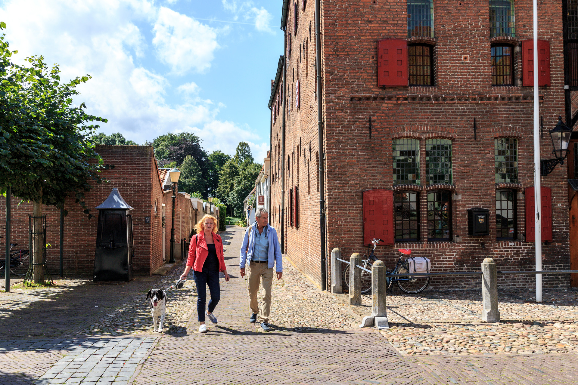 Man en vrouw wandelen lang Museum Elburg