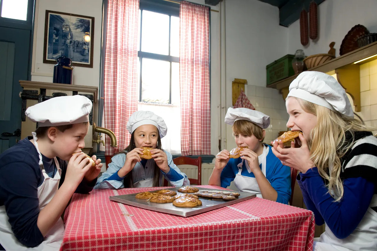 Etende kinderen aan tafel bij Bakkerijmuseum